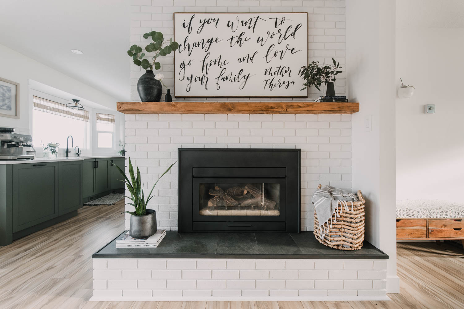 Painted brick fireplace with rustic wood mantel and tile hearth