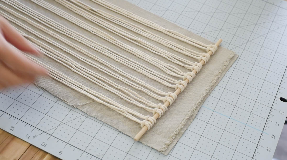 Larks head knot to attach macrame cord to the dowel